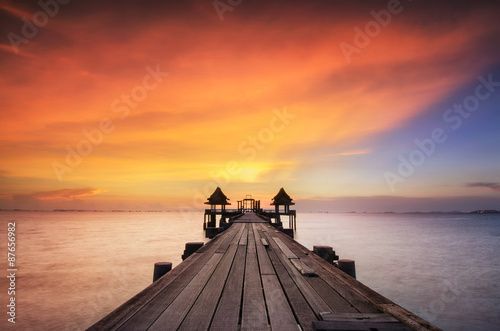 Landscape of Wooded bridge in the port between sunrise © weerasak