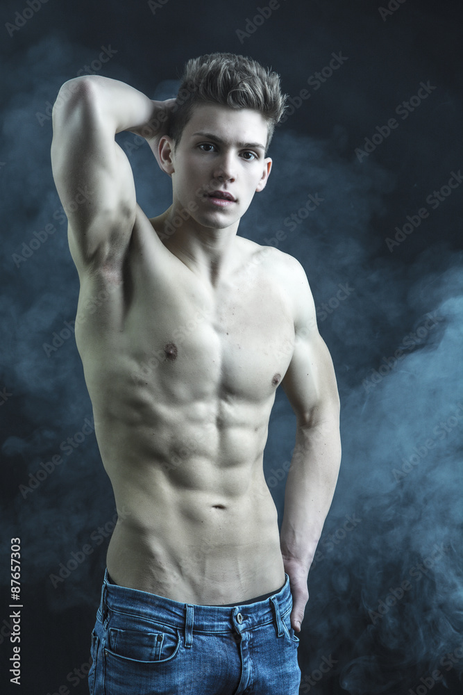 Fototapeta premium Handsome young bodybuilder in relaxed pose