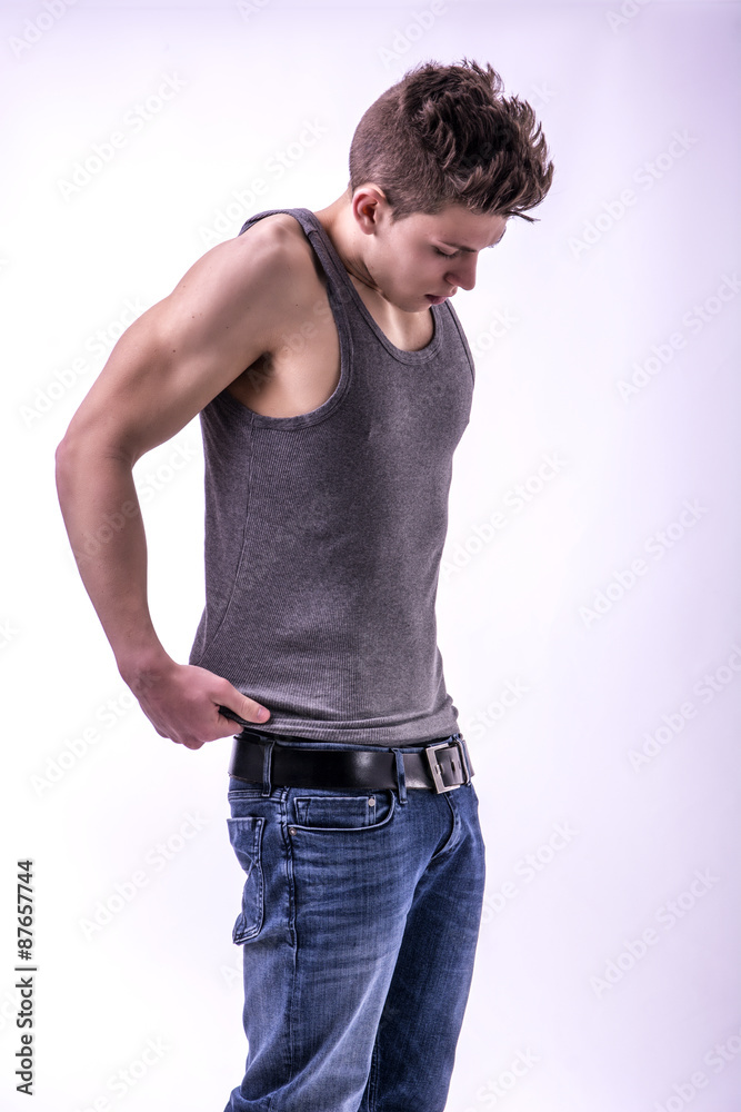 Attractive trendy young man undressing Attractive trendy young man undressing
