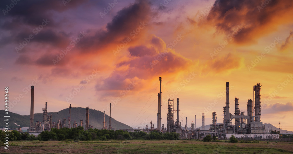 Oil refinery at twilight with sky background.