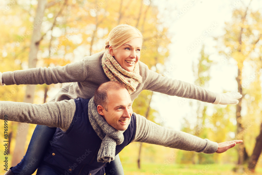 smiling couple having fun in autumn park smiling couple having fun in autumn park