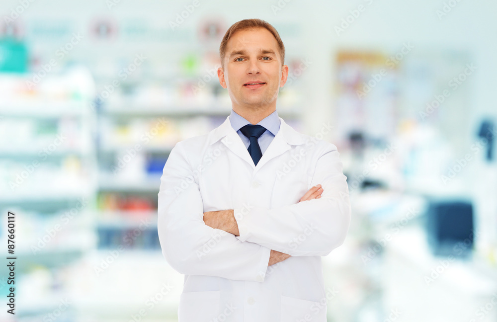 smiling male pharmacist in white coat at drugstore smiling male pharmacist in white coat at drugstore