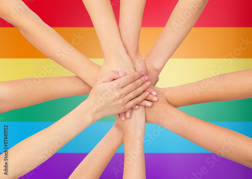 close up of women with hands on top over rainbow