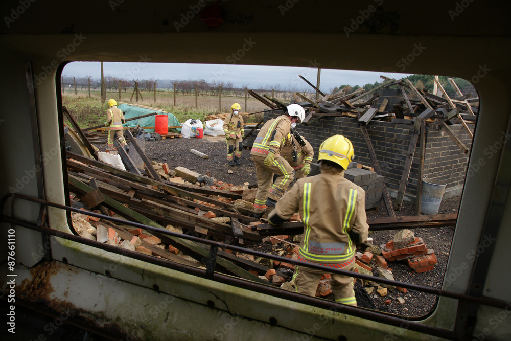 Fototapeta premium fire-fighters at building collapse disastor