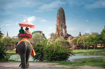 Tourists on an elephant ride tour of the ancient city Ayutaya ,thailand