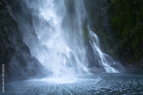 A waterfall in Milford sound , New Zealand