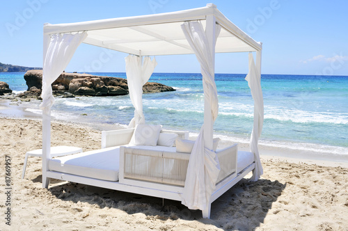 white bed in a beach club in Ibiza, Spain photo