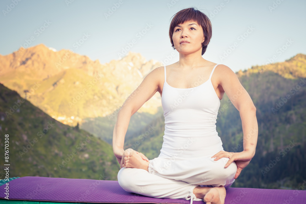 Beautiful asian woman relaxing and meditating outdoor at mountain