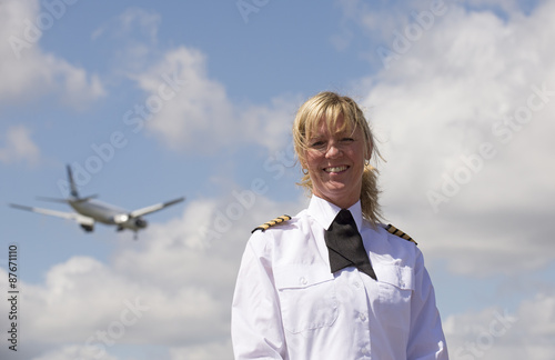 Portrait of a pilot with a passenger jet in the sky