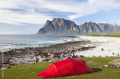 rotes Zelt in norwegischer Küstenlandschaft auf den Lofoten photo