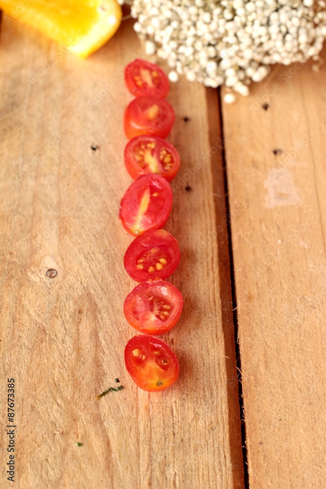 Oranges fruits and tomatoes sliced on wood background Oranges fruits and tomatoes sliced on wood background