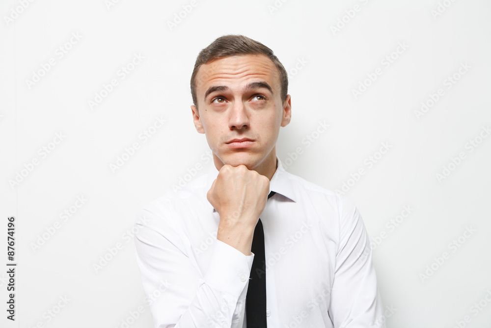 Businessman looking thoughtful while holding his head Businessman looking thoughtful while holding his head