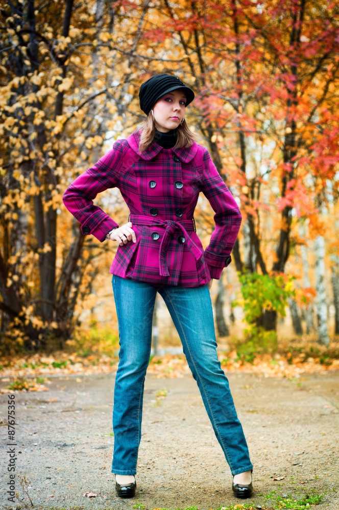 Smiling girl in pink coat in the fall Smiling girl in pink coat in the fall