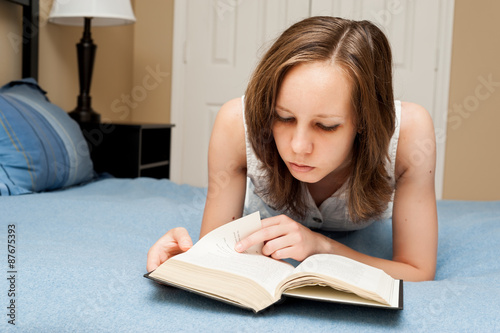 Student girl reading a book inddors