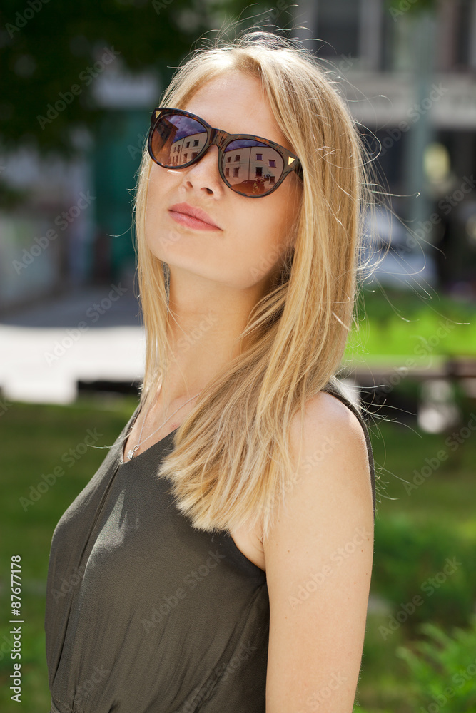 Charming blonde girl in sunglasses