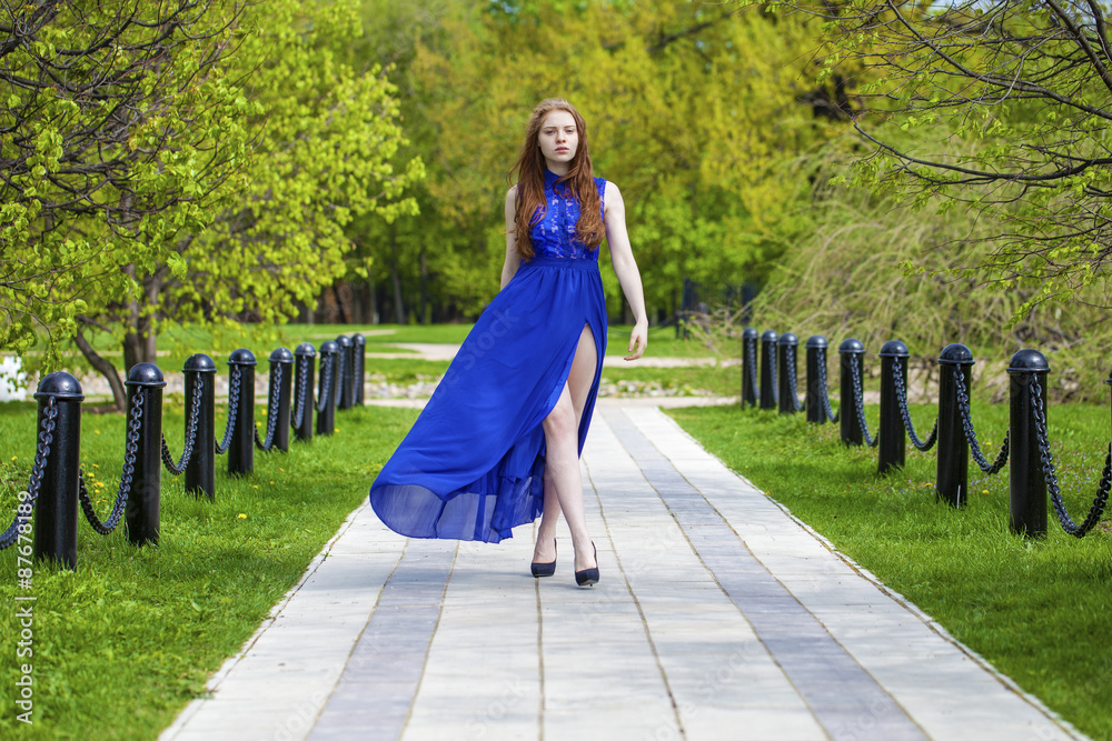 Spring beauty girl with long red blowing hair outdoors Spring beauty girl with long red blowing hair outdoors