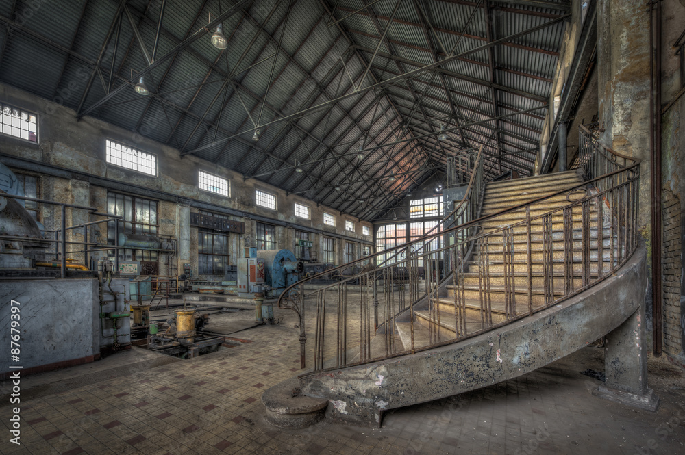 Imposing staircase inside the hall of an abandoned power plant