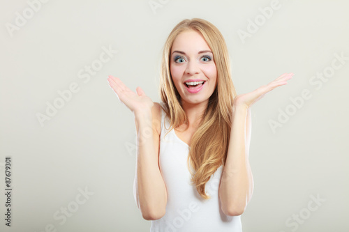 Blonde girl spreading hands with joy