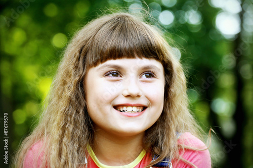 Happy child girl on a green background