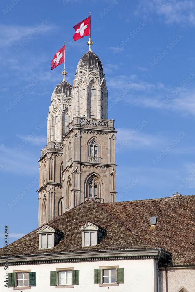 Grossmunster towers decorated with Swiss Flags