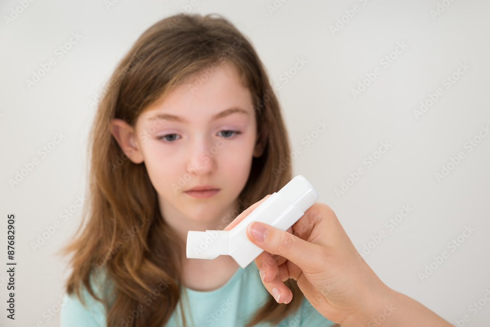 Person Hands With Inhaler In Front Of Girl Person Hands With Inhaler In Front Of Girl