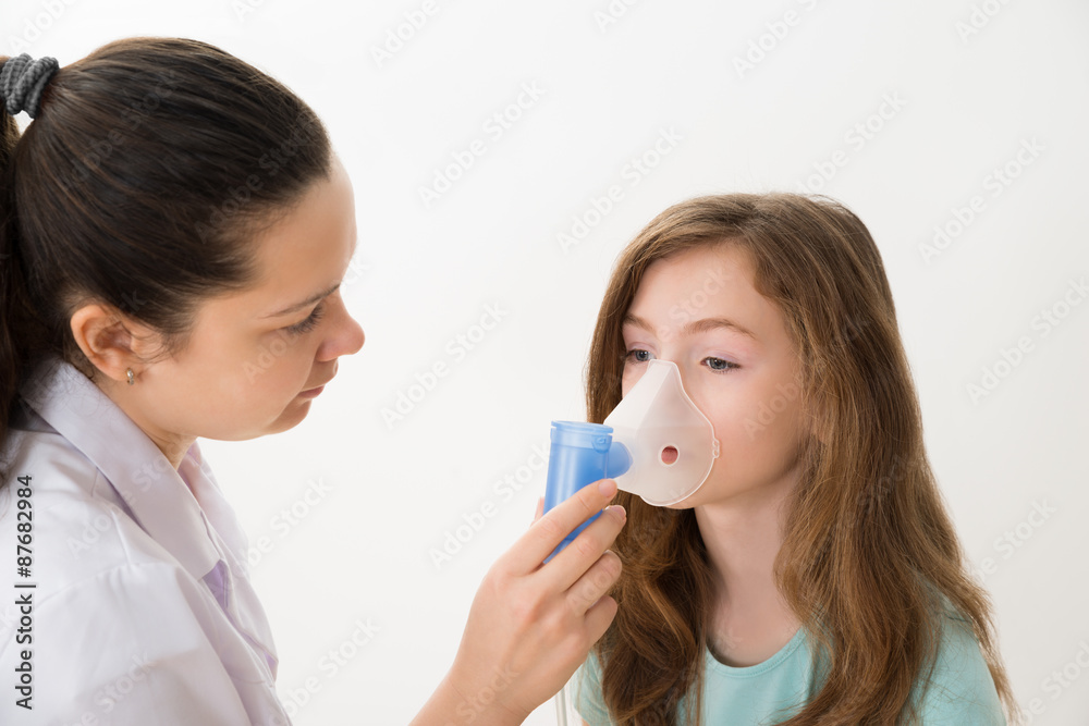 Doctor Using Inhaler Mask On Girl Doctor Using Inhaler Mask On Girl