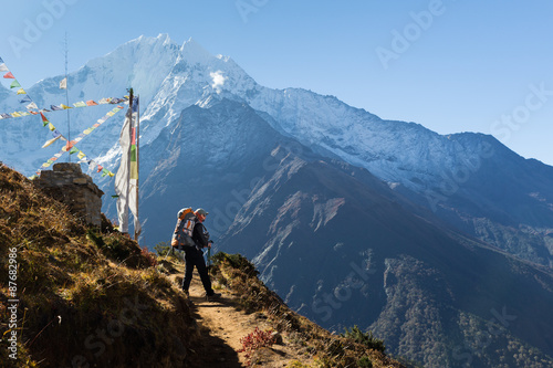 Woman backpacker standing trail, Kangtega mountain ridge snow pe photo