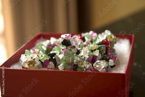 This is a photograph of mixed Gemstone necklace in a box 