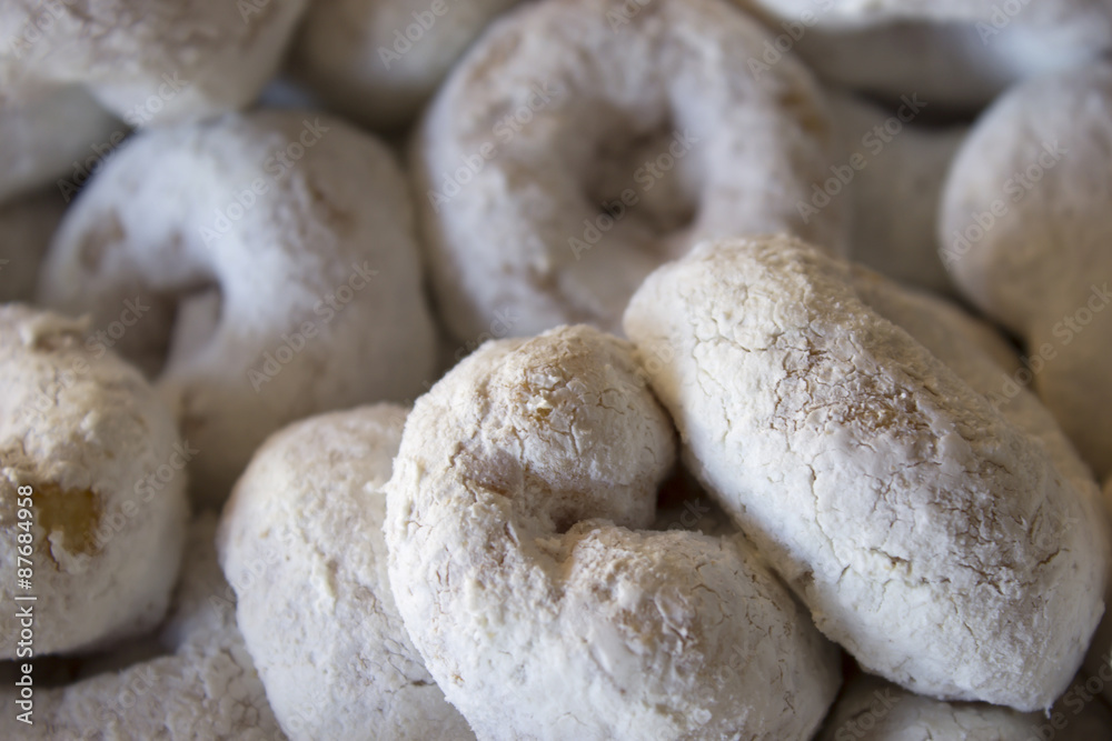 This is a photograph of Powdered sugar donuts This is a photograph of Powdered sugar donuts