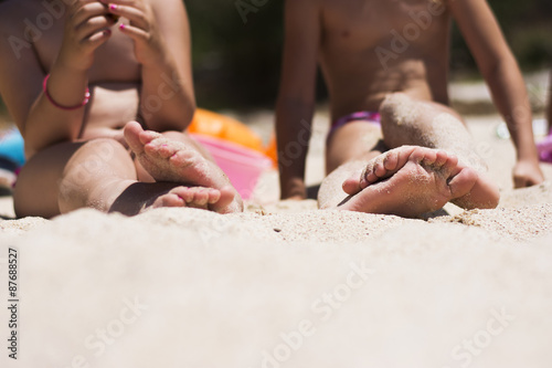 Children's feet in sand on the beach
