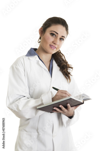 Young beautiful female doctor holding a notebook