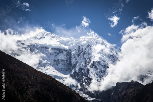 Snowy mountain peak and clouds  Himalaya  Nepal