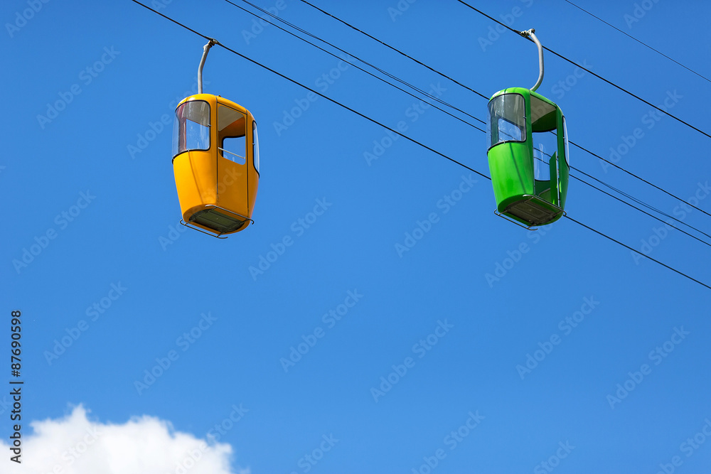 Suspended cabin. Photo of two bright viewing booths against the sky Suspended cabin. Photo of two bright viewing booths against the sky