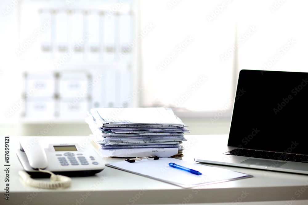 office desk a stack of computer paper reports work forms