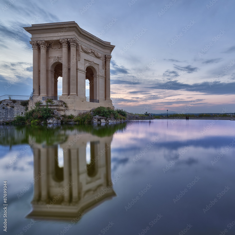 Peyrou Pavilion in Montpellier with reflection and sunset colors