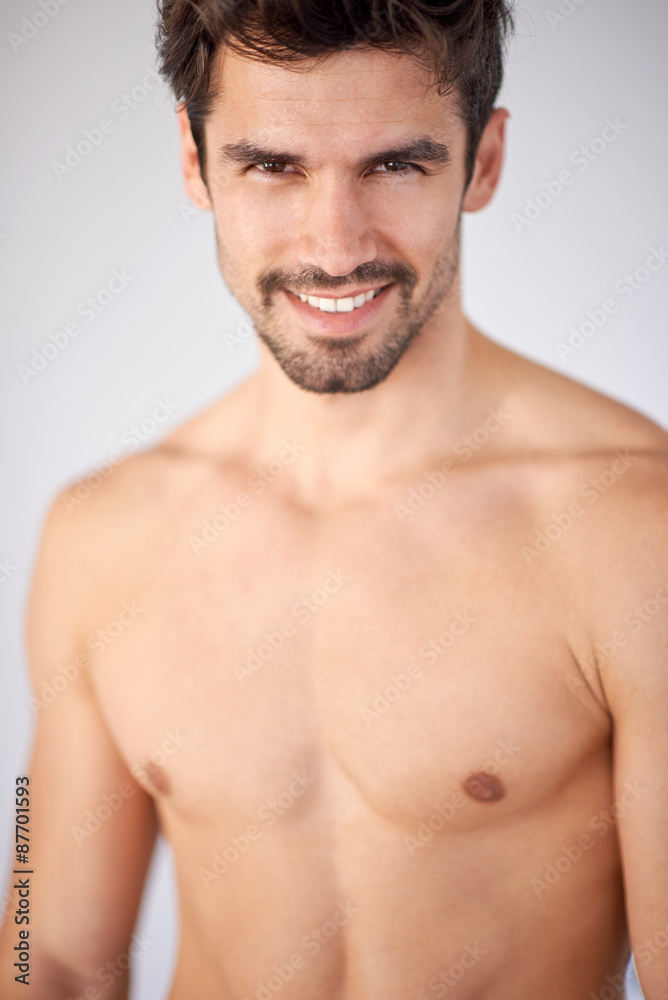 shirtles handsome young man in jeans