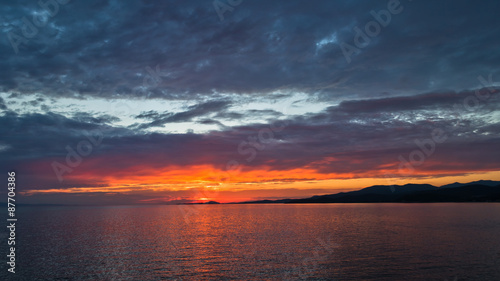 Colorful sunset at sea, near west coast of Sithonia in Greece