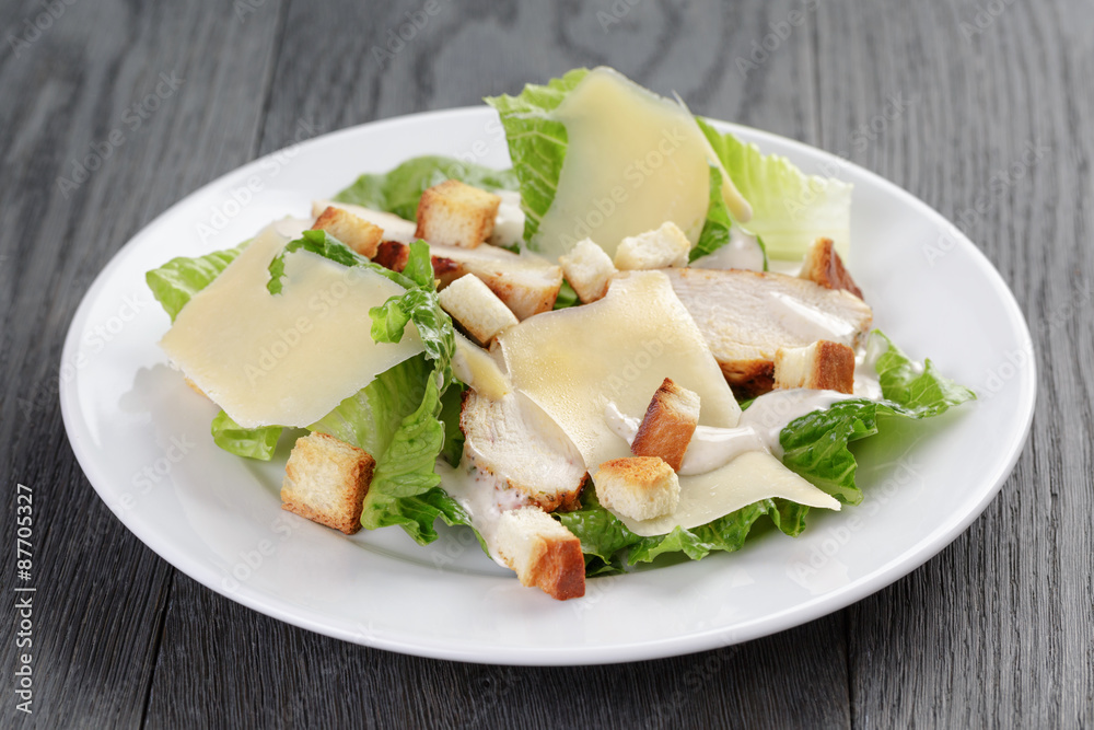 caesar salad with chicken on oak table caesar salad with chicken on oak table