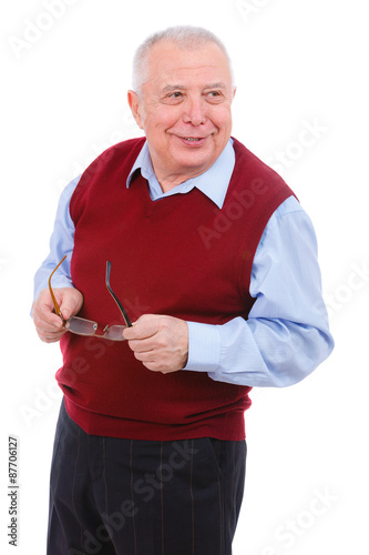 Portrait of happy and smile senior old teacher man holds his glasses, wearing cardigan marsala color and shirt, isolated on white background. Human emotions and facial expressions. Education concept