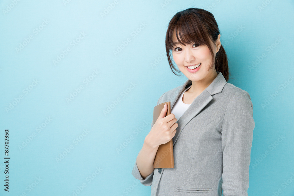 portrait of asian businesswoman on blue background portrait of asian businesswoman on blue background