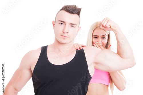 Impressed woman by personal trainer muscles