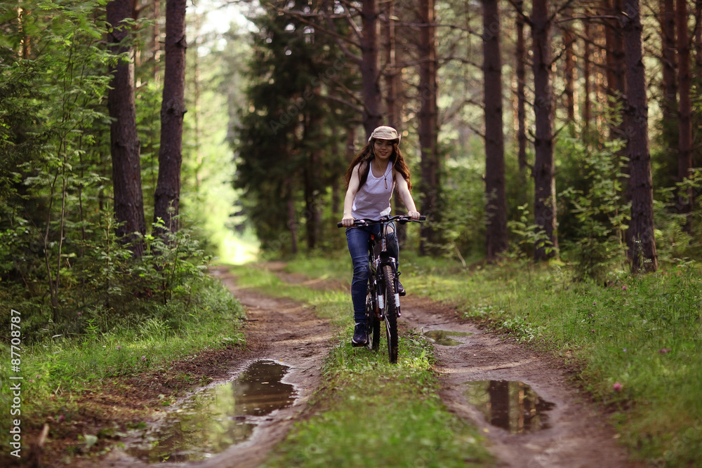 young girl on a sports bike in a summer forest young girl on a sports bike in a summer forest