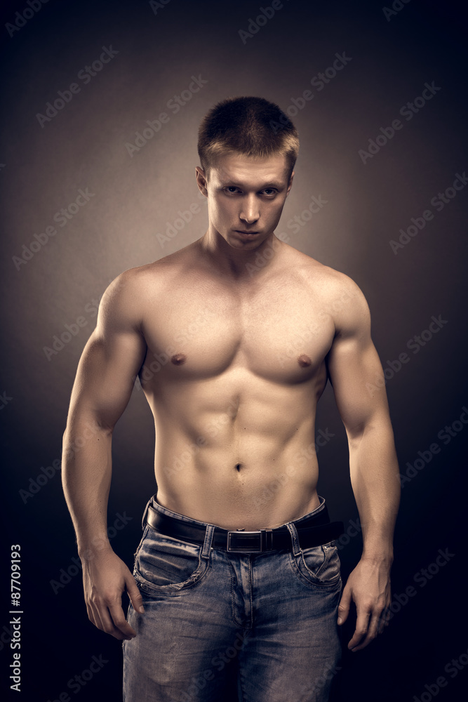 Healthy muscular young man  posing in studio