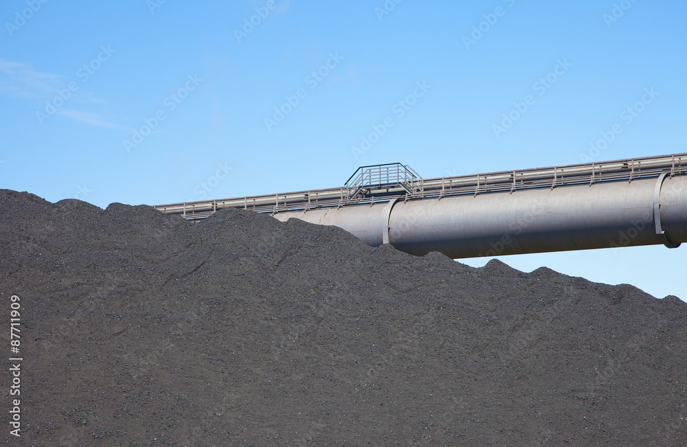 View at black coal deposit with transporter