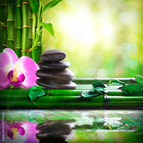 Stacked stones on bamboo reflected in water massage and relax