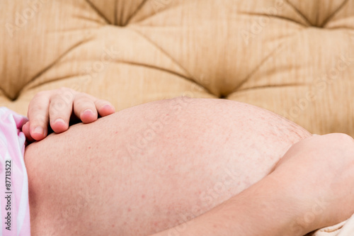 Pregnant Woman holding her hands on her belly
