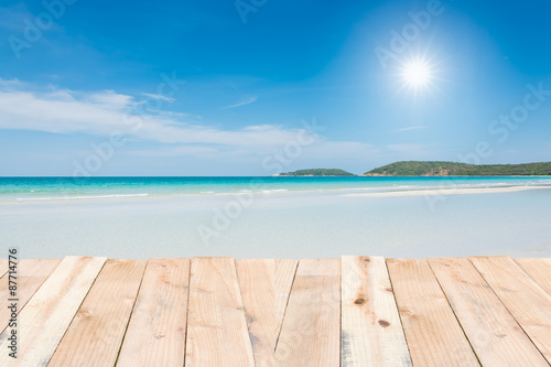 Wood terrace on beach blue sky