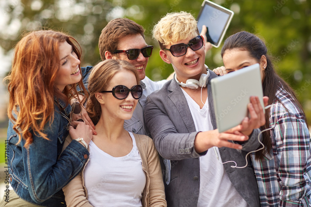 Fototapeta premium students or teenagers with tablet pc taking selfie