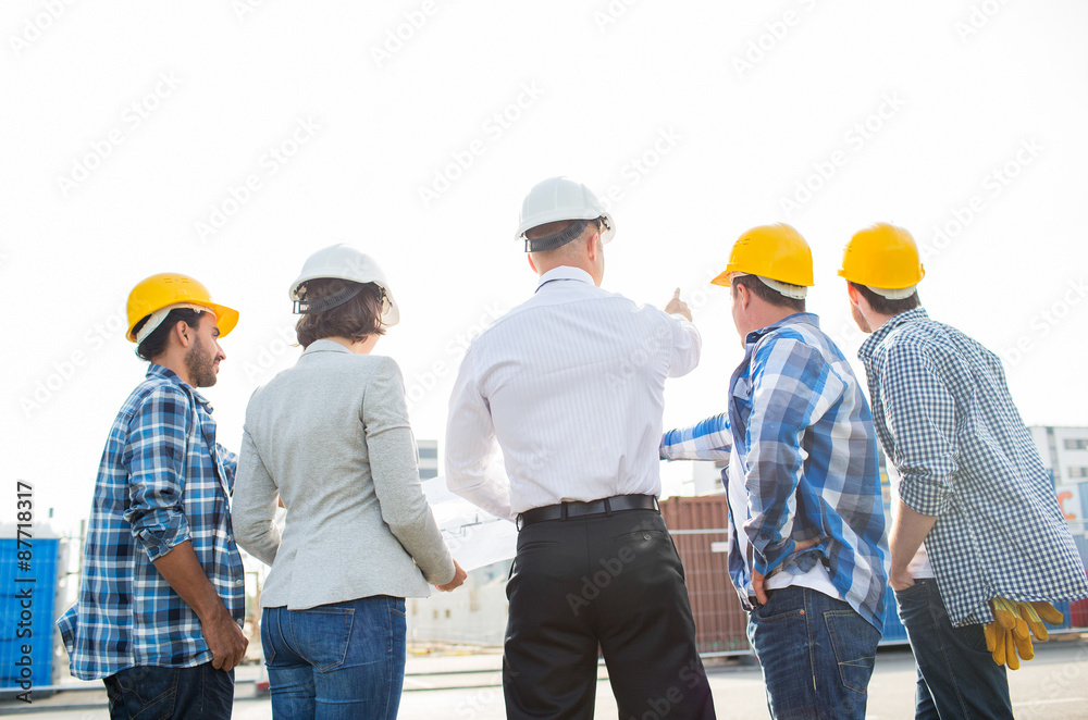 group of builders and architects at building site group of builders and architects at building site