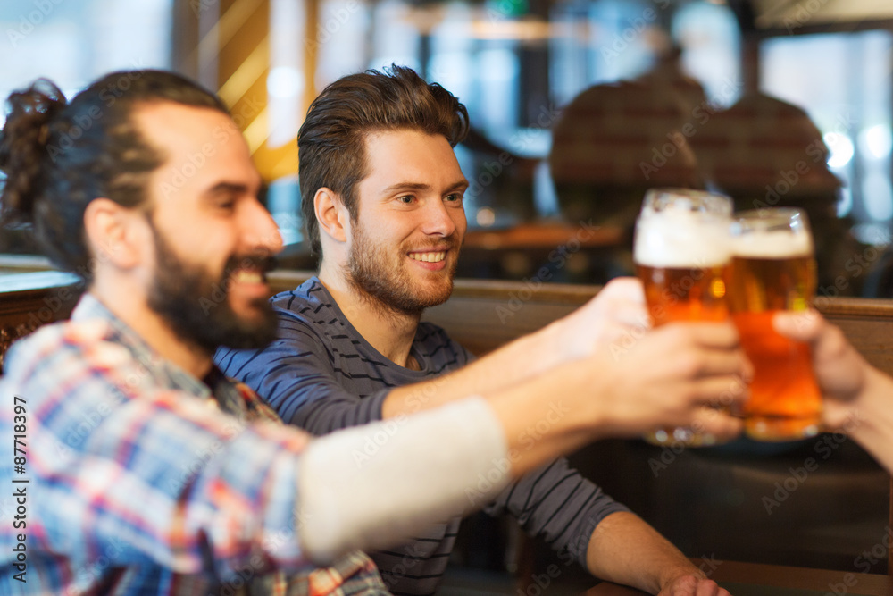 happy male friends drinking beer at bar or pub